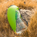 Blue portable pet water bottle with attached drinking bowl for dogs and cats