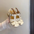 Women's woven Roman shoes with round toe and buckle in apricot and black colours on display