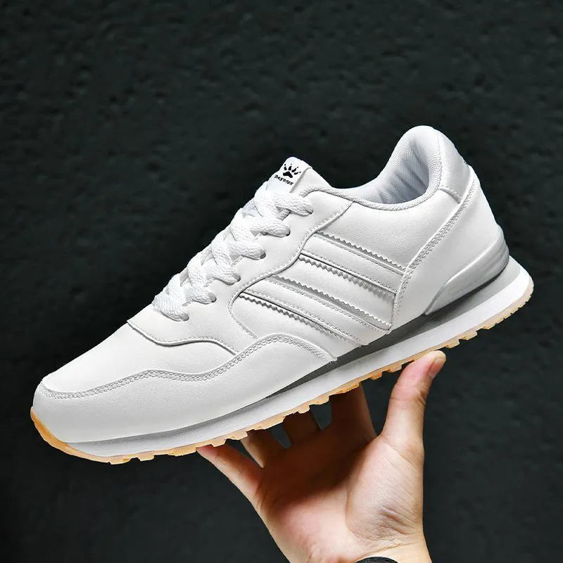 Men's black leather casual sports shoes with carved wing pattern detail and a high heel.