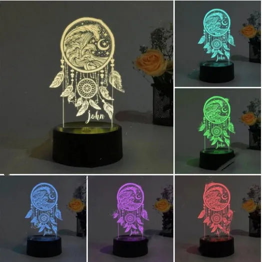 Modern black and clear acrylic dream catcher night light with remote control on a table.