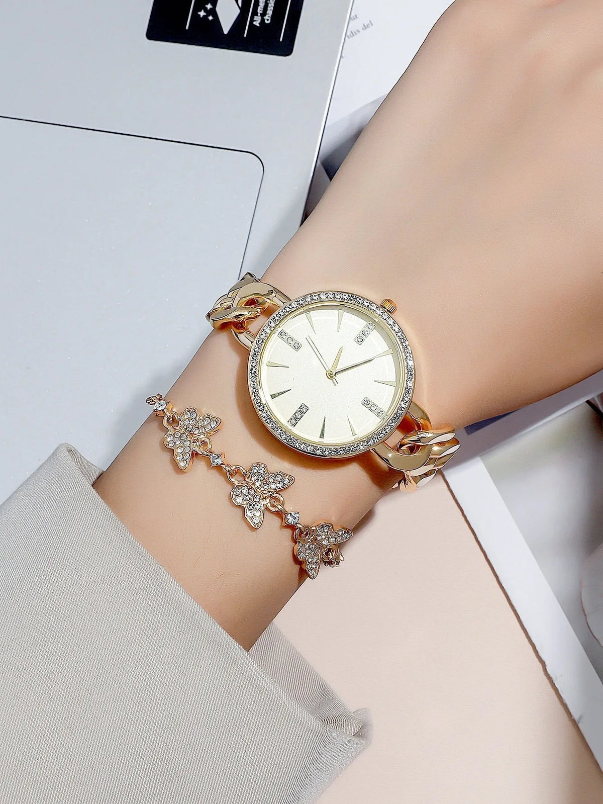 Women's wrist watch with thin alloy strap, circular dial, and titanium metal jewellery buckle