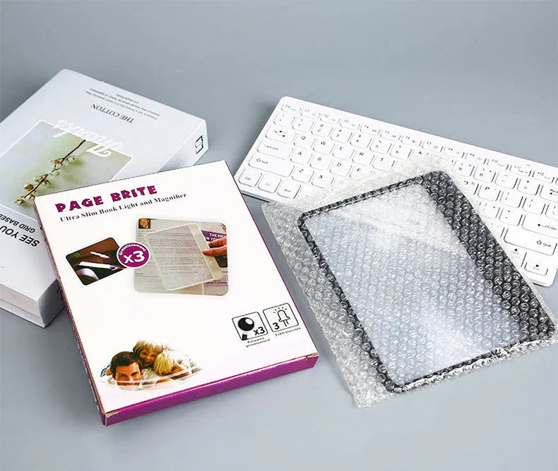 Black or white magnifying glass with integrated LED reading lamp, showing 180x140mm size and 3x magnification lens.