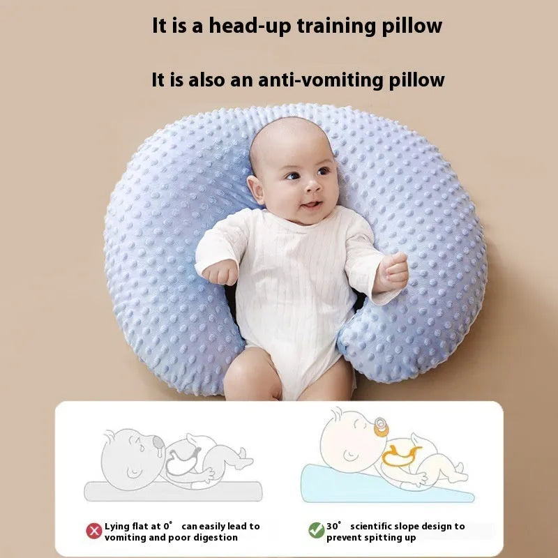 Grey nursing pillow with curved shape for feeding and spill prevention.