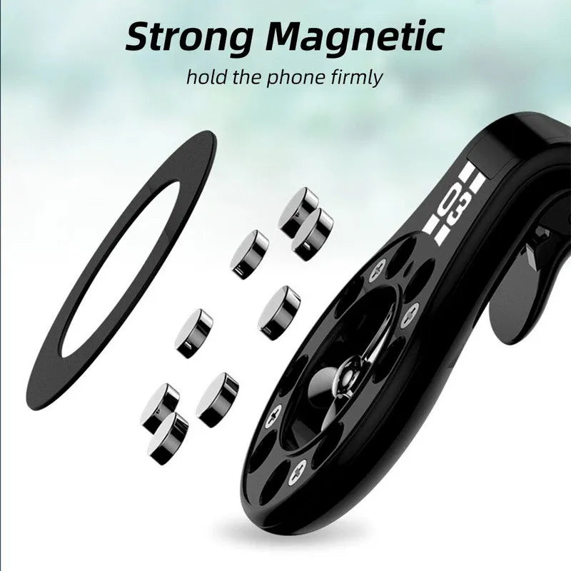Black magnetic phone holder clipped onto a car air vent, showing phone attached and 360-degree rotation.