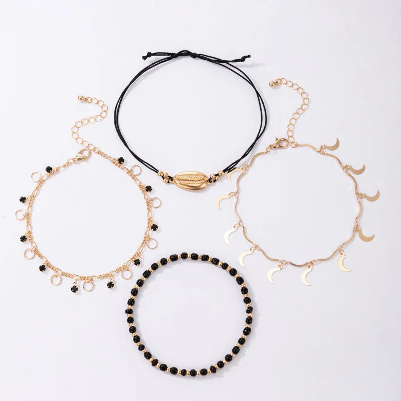 Women's gold tone alloy anklet set with hollow circles, shell beads, and black rice beads, four pieces