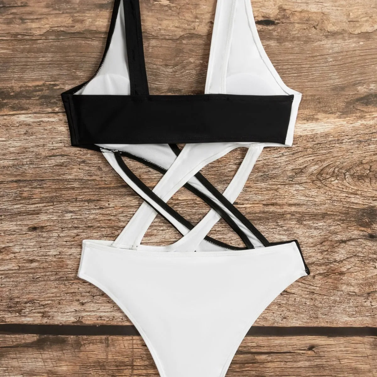 White women's one-piece swimsuit with colour-block panels and hollow-out design details.