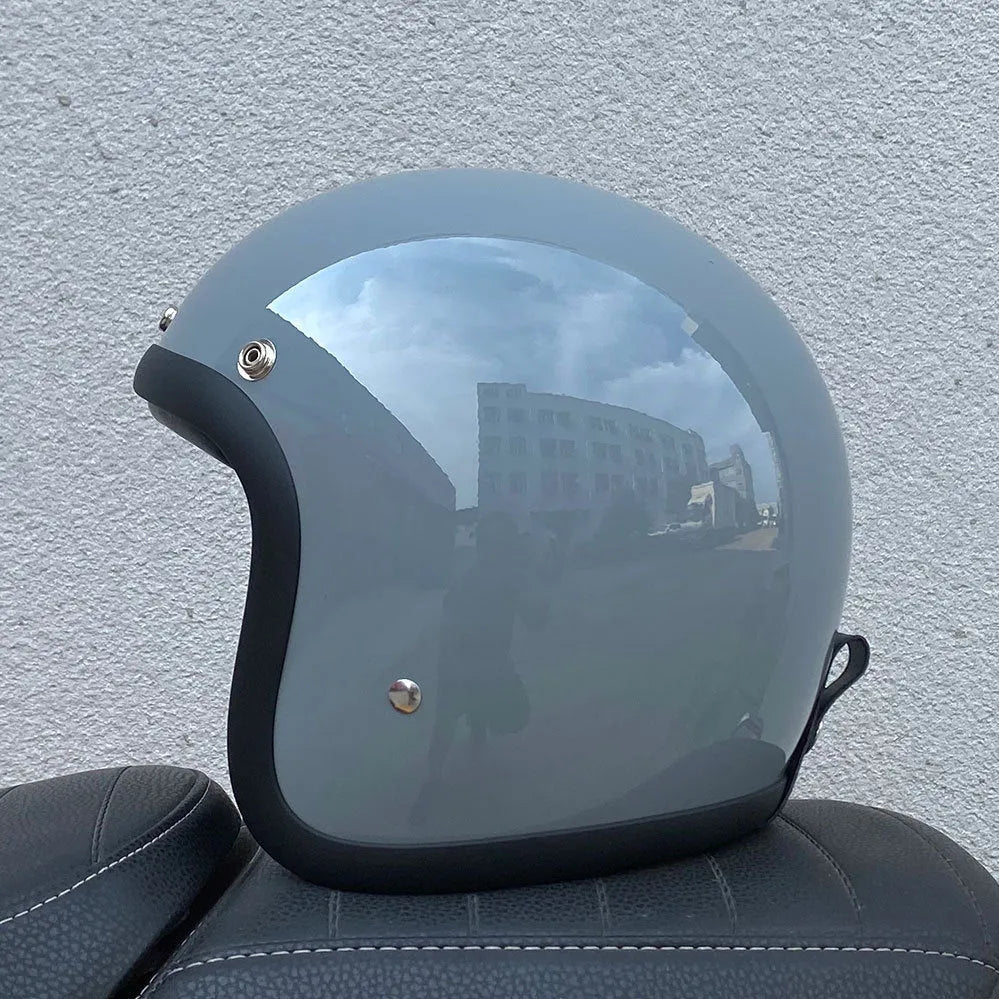 Cement Grey retro open-face motorcycle helmet with a smooth glass fibre shell on a plain background.