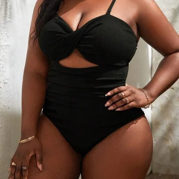 Black plus size women's slimming one-piece swimsuit with sleeveless triangle style design