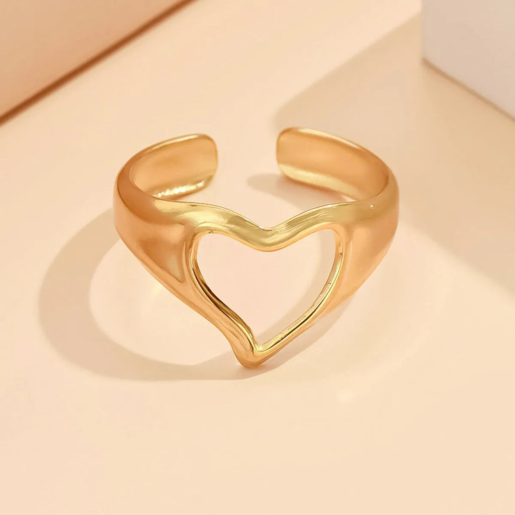 Adjustable hollow heart open ring in stainless steel with U-shaped band and rose motif, shown in steel or gold colour