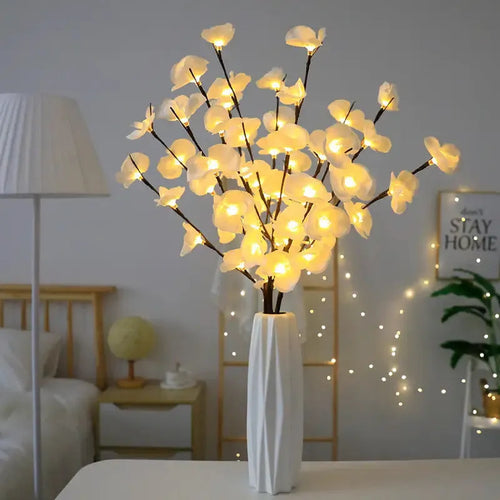 Pink silk orchid LED branch light, 65cm long, with glowing warm white LEDs on fabric petals and plastic stem.