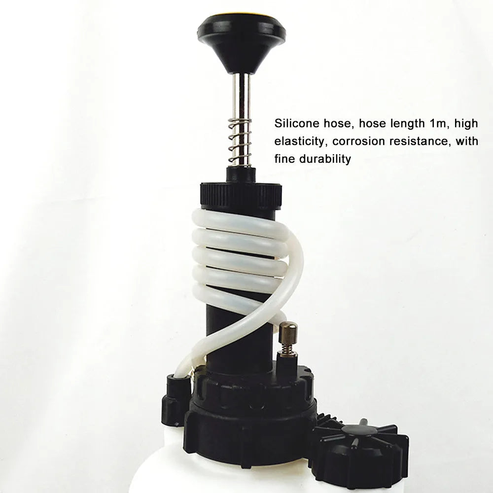 White 3-litre brake oil tank and automotive fluid replacement tool with copper and iron parts on a workbench.