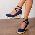 Dark blue suede straw woven wedge closed toe high heels with buckle fastening on a white background