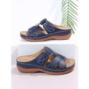 Women's red peep toe wedge sandals with a velcro strap closure on a fish mouth hollow wedge heel.