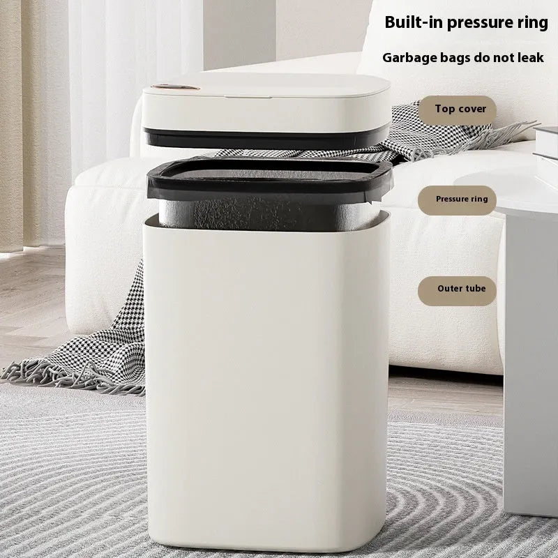 Automatic sensor bin with square white body and open induction lid on a kitchen floor.