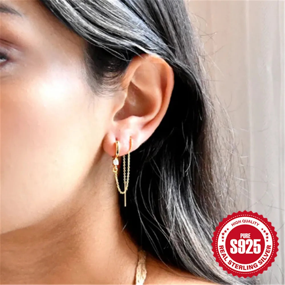 S925 sterling silver geometric stud earrings with diamond, flower, and tassel chain design in a golden colour.