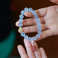DIY adjustable aquamarine bead bracelet with pearl accents and a Chinese style fox Fengjiu charm.