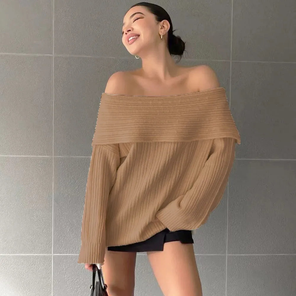 Woman wearing a loose-fitting, long-sleeved, off-neck pullover sweater in a solid colour