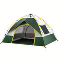Dark green and silver automatic pop-up camping tent pitched outdoors.