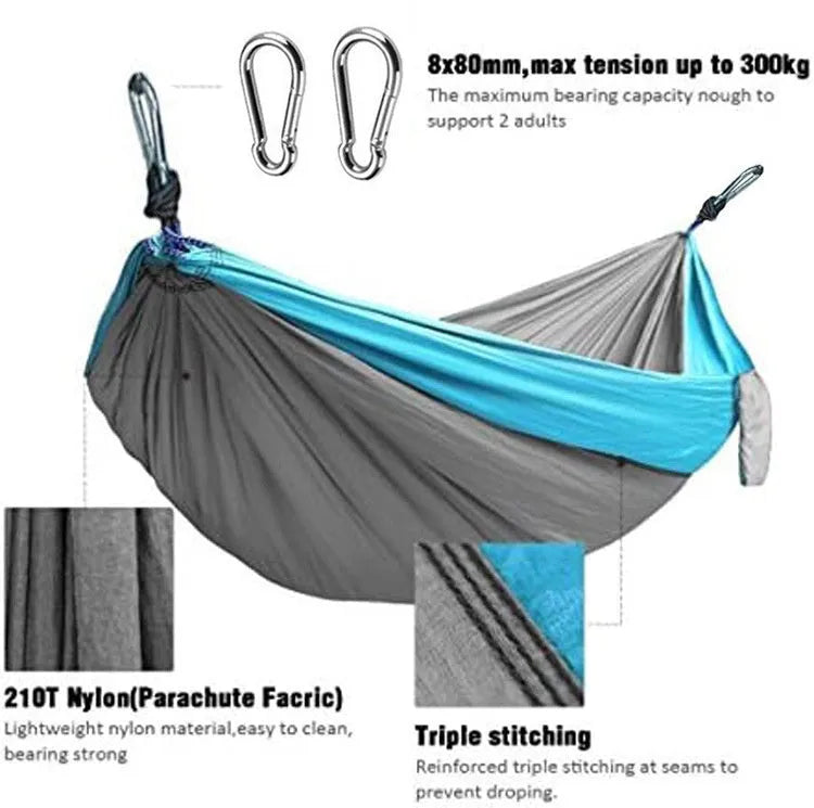 Blue parachute nylon camping hammock hung between two trees, showing its full 270cm length and 140cm width.