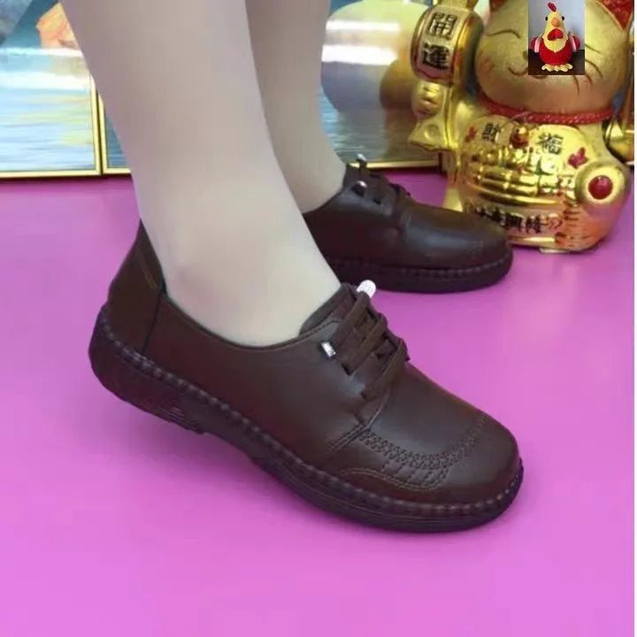 Women's soft leather low heel shoes in black with front lace-up and non-slip rubber sole