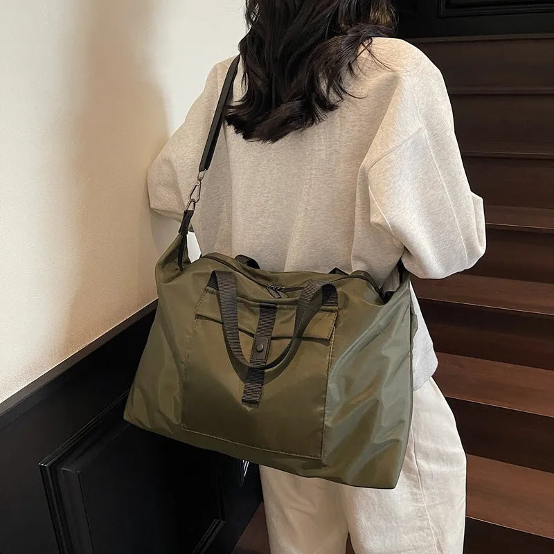 Grey one-shoulder travel backpack with 55 litre capacity showing Oxford cloth construction