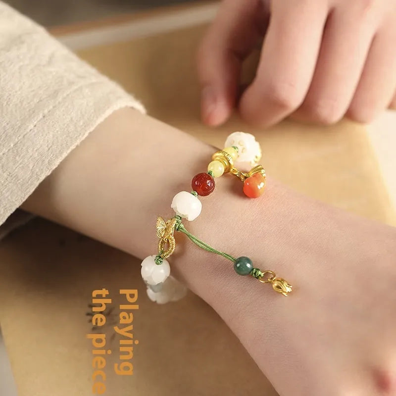 White jade Bodhi bracelet with lotus and pumpkin beads on open rope with ring clasp