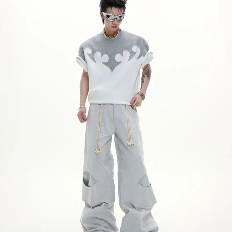 Grey men's loose-fit cotton T-shirt with textured 3D stitching and burnt flower detail on chest, short sleeves, round neck.