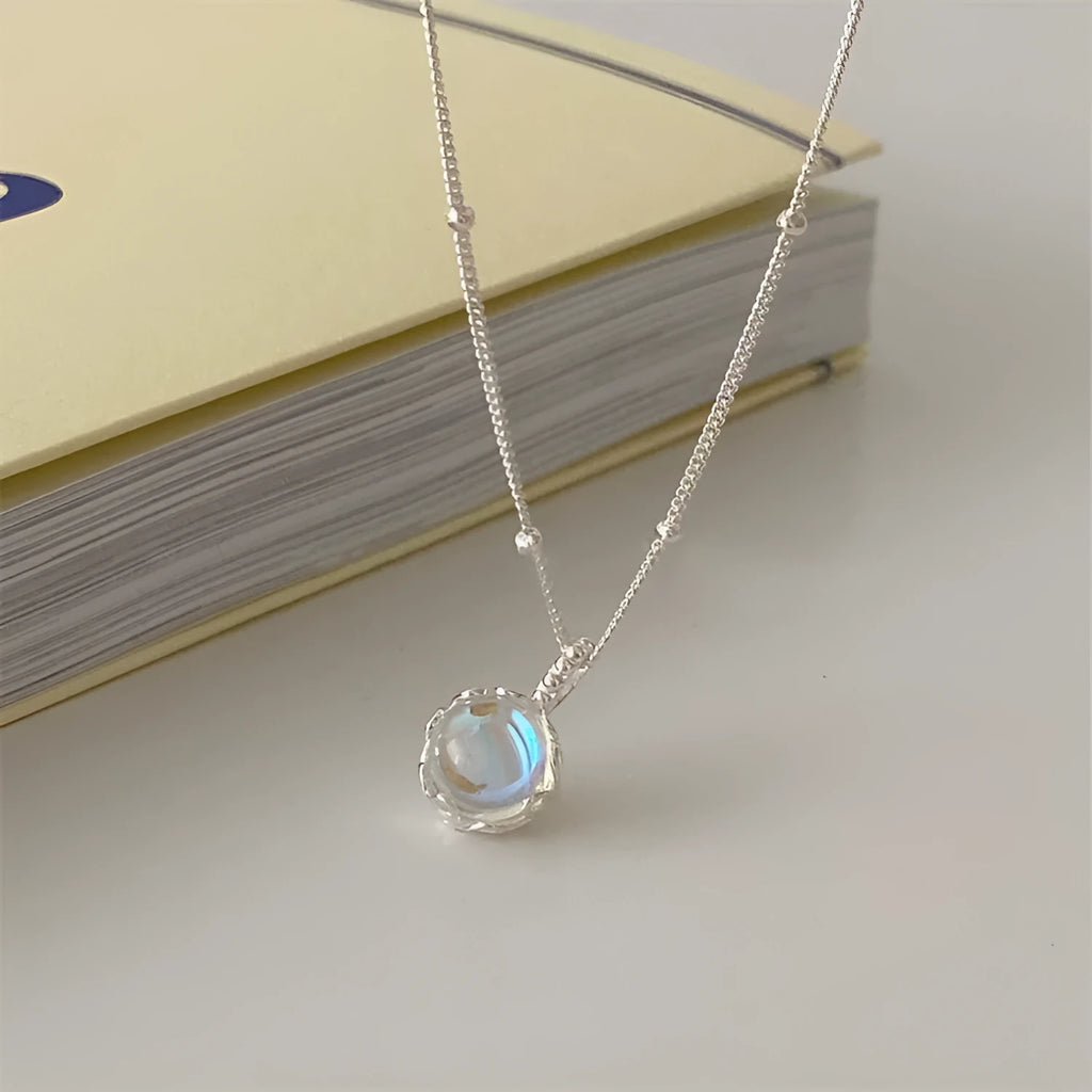 925 silver ornamental stone necklace with round geometric pendant on a curb chain.