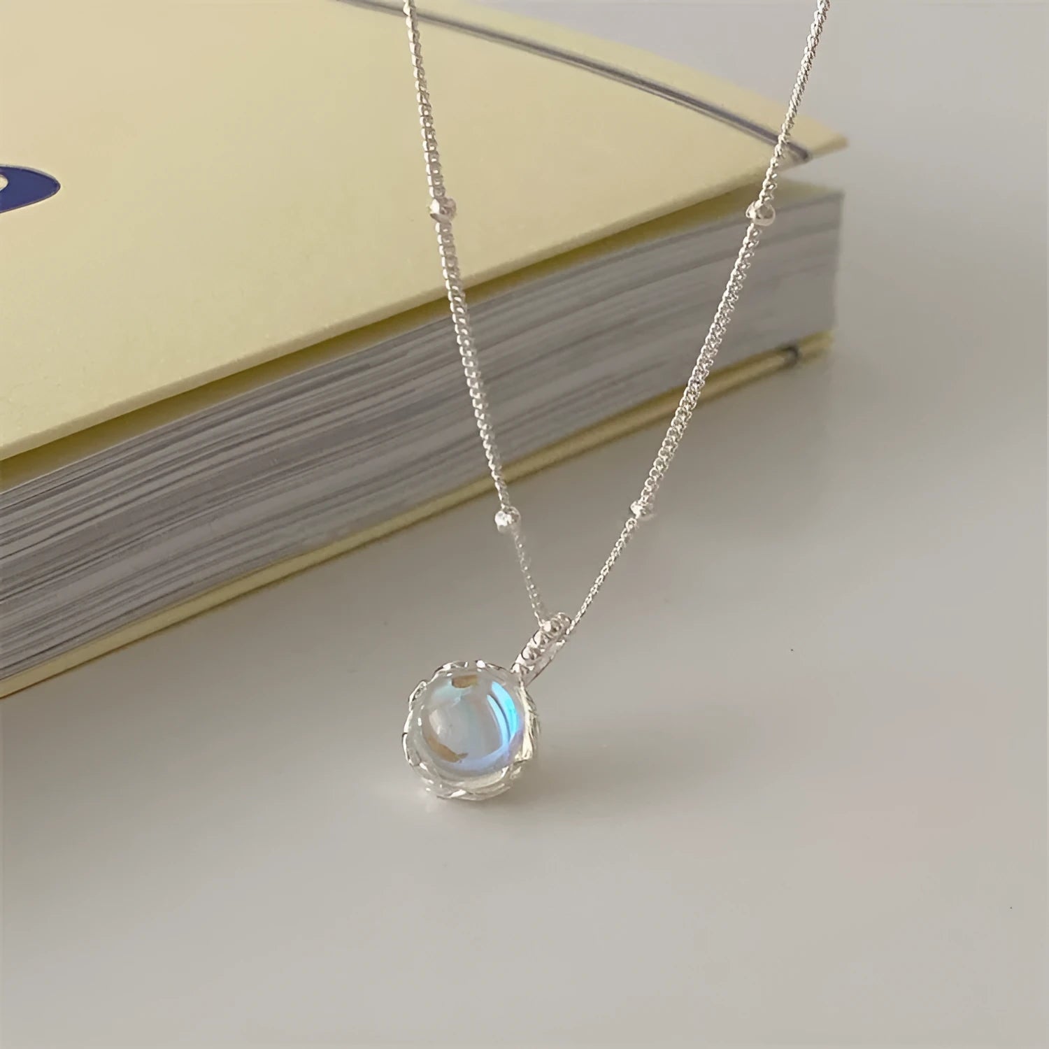 925 silver ornamental stone necklace with round geometric pendant on a curb chain.