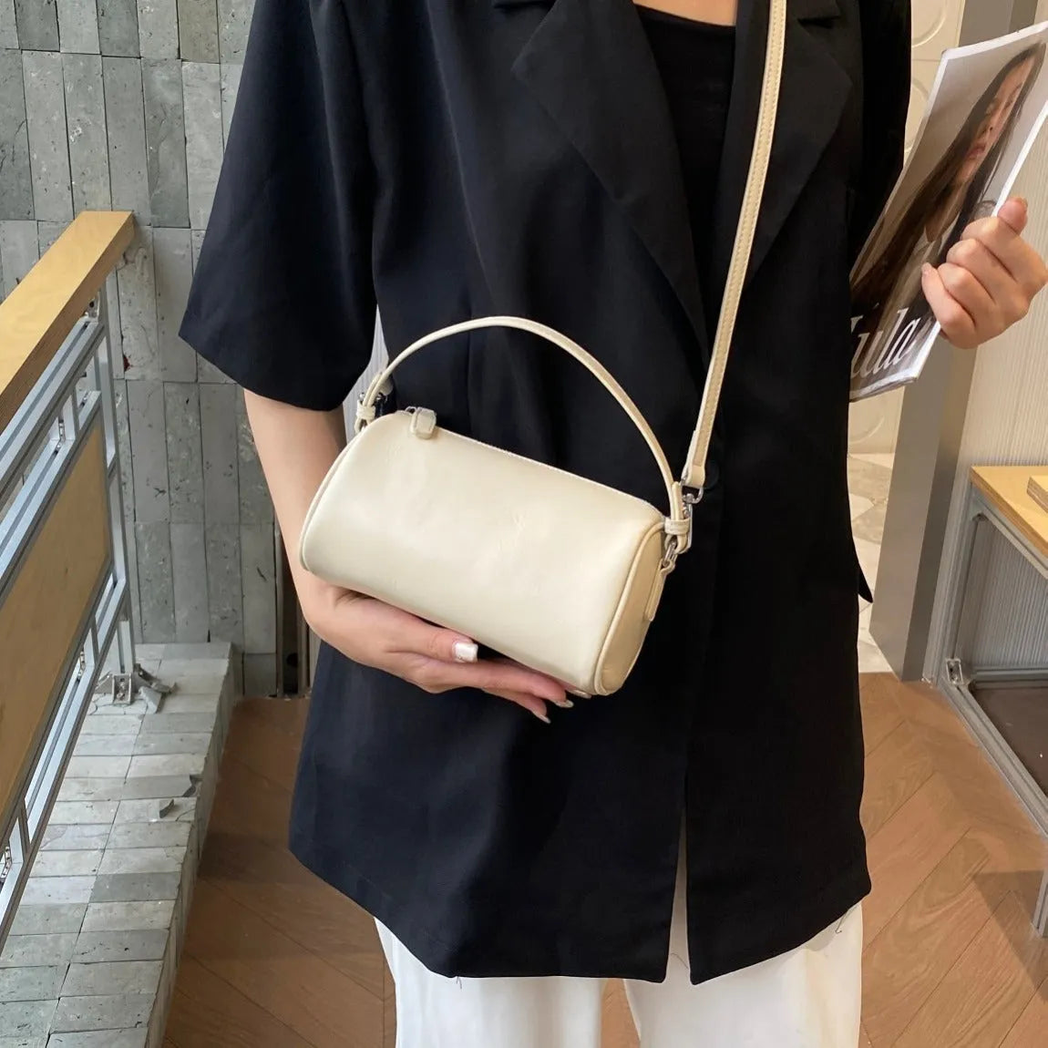 Genuine leather mobile phone crossbody bag with cylindrical design in six colour options showing sewing thread detailing