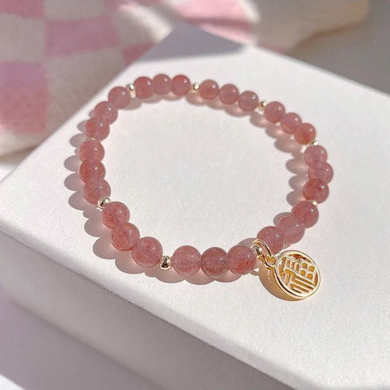 Handmade strawberry quartz blessing card bracelet with glass construction and adjustable universal wrist size