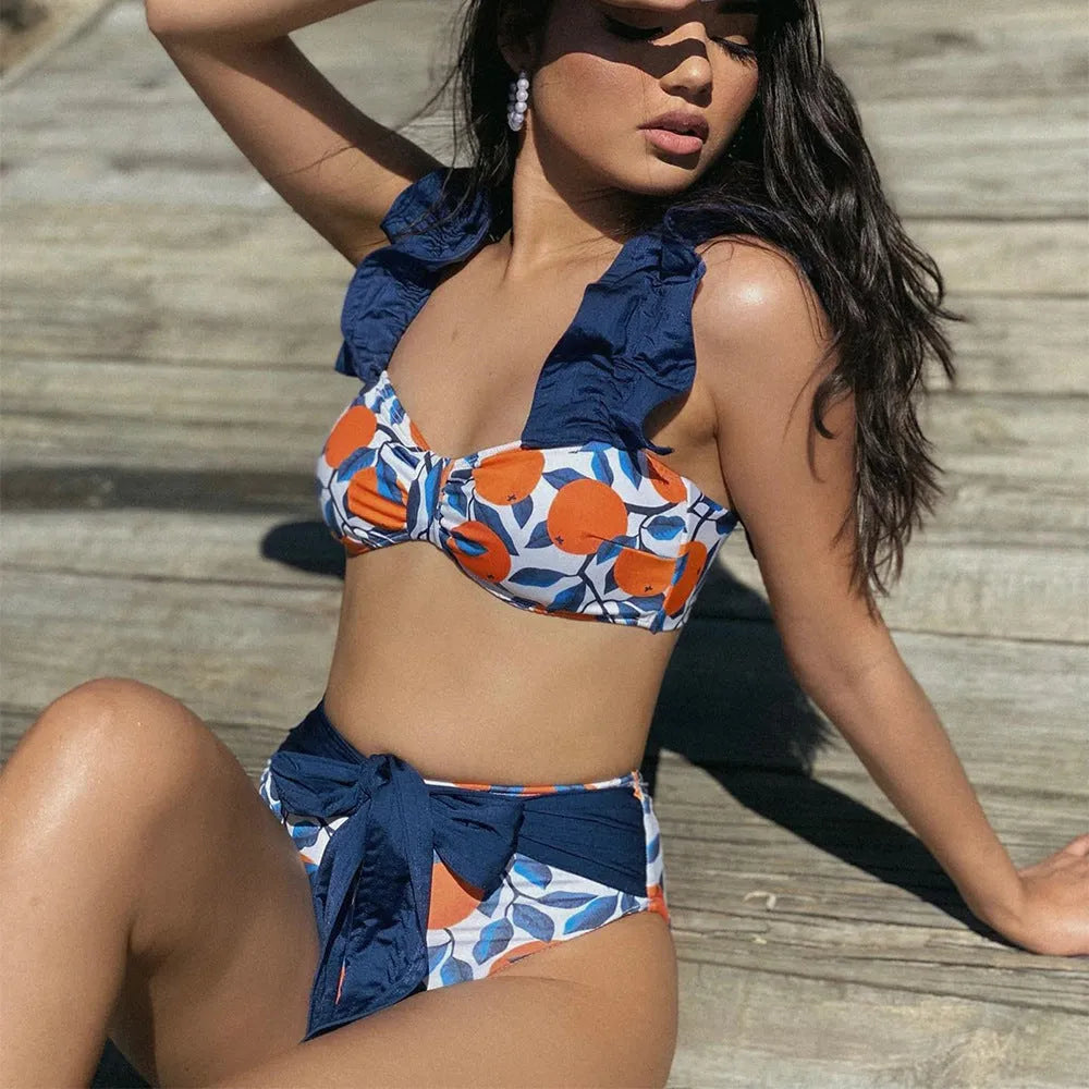 Blue and orange leaf print women's high waist bikini swimsuit on a mannequin.