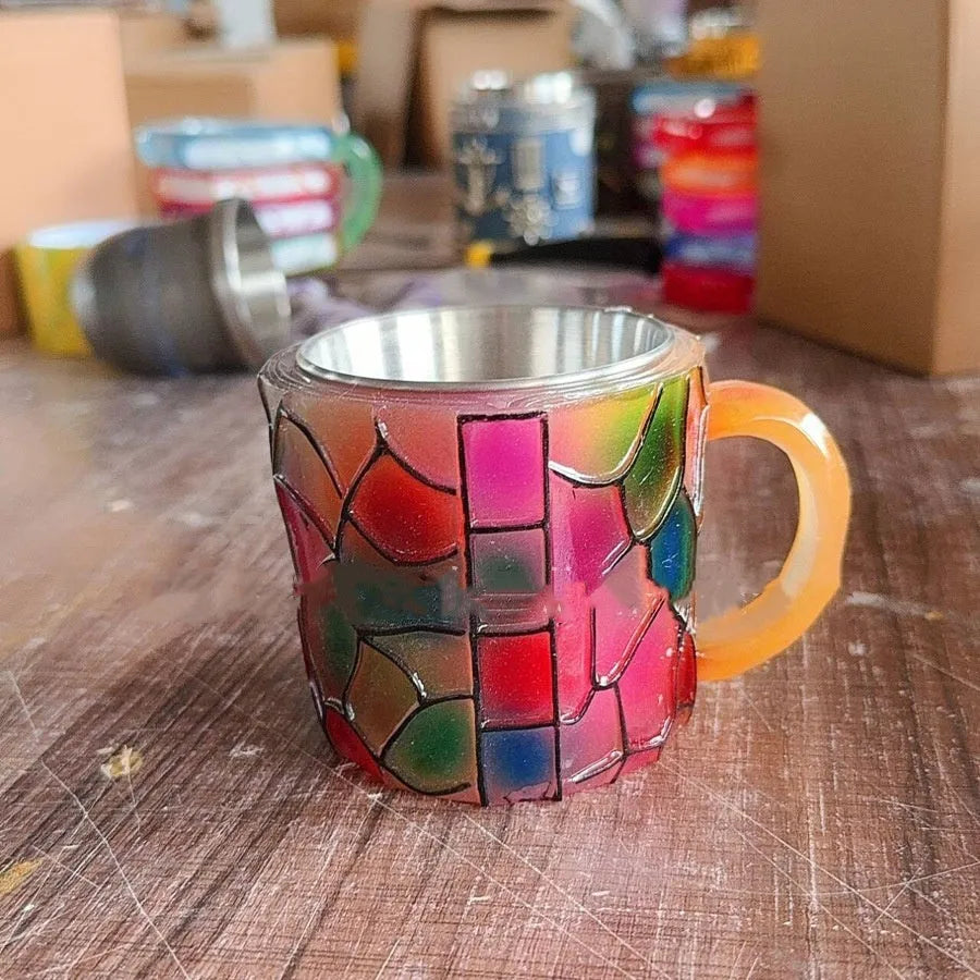 Painted synthetic resin coffee cup for holding bookmarks and pens.