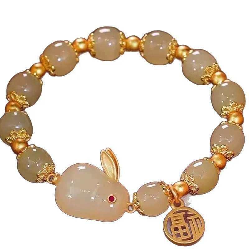 A glass and coloured glaze bracelet with a rabbit motif and a peace buckle clasp.