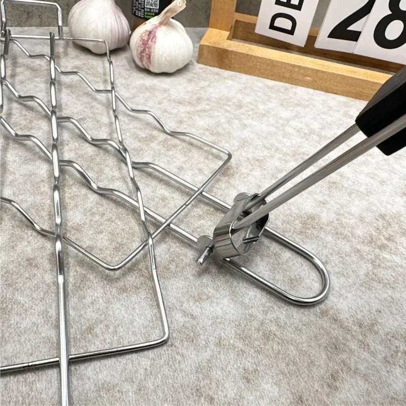 Stainless steel removable folding outdoor barbecue net, square modern style, with black handle, placed over charcoal fire.