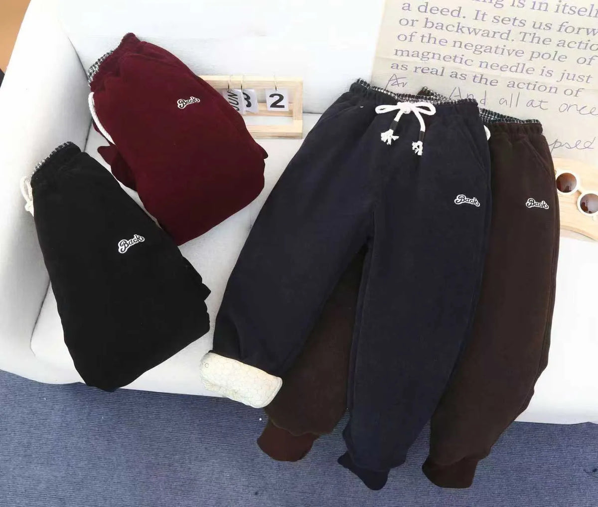 Forest Star children's trousers in black, side view showing drawstring waist and tapered legs with tight cuffs