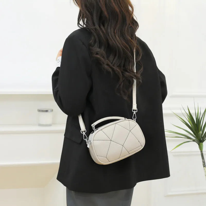 Small round patchwork bag in PU with visible stitching details, shown in beige colour