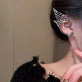 Butterfly wing ear clip made of alloy with electroplated finish, geometric textured design, available for left or right ear.