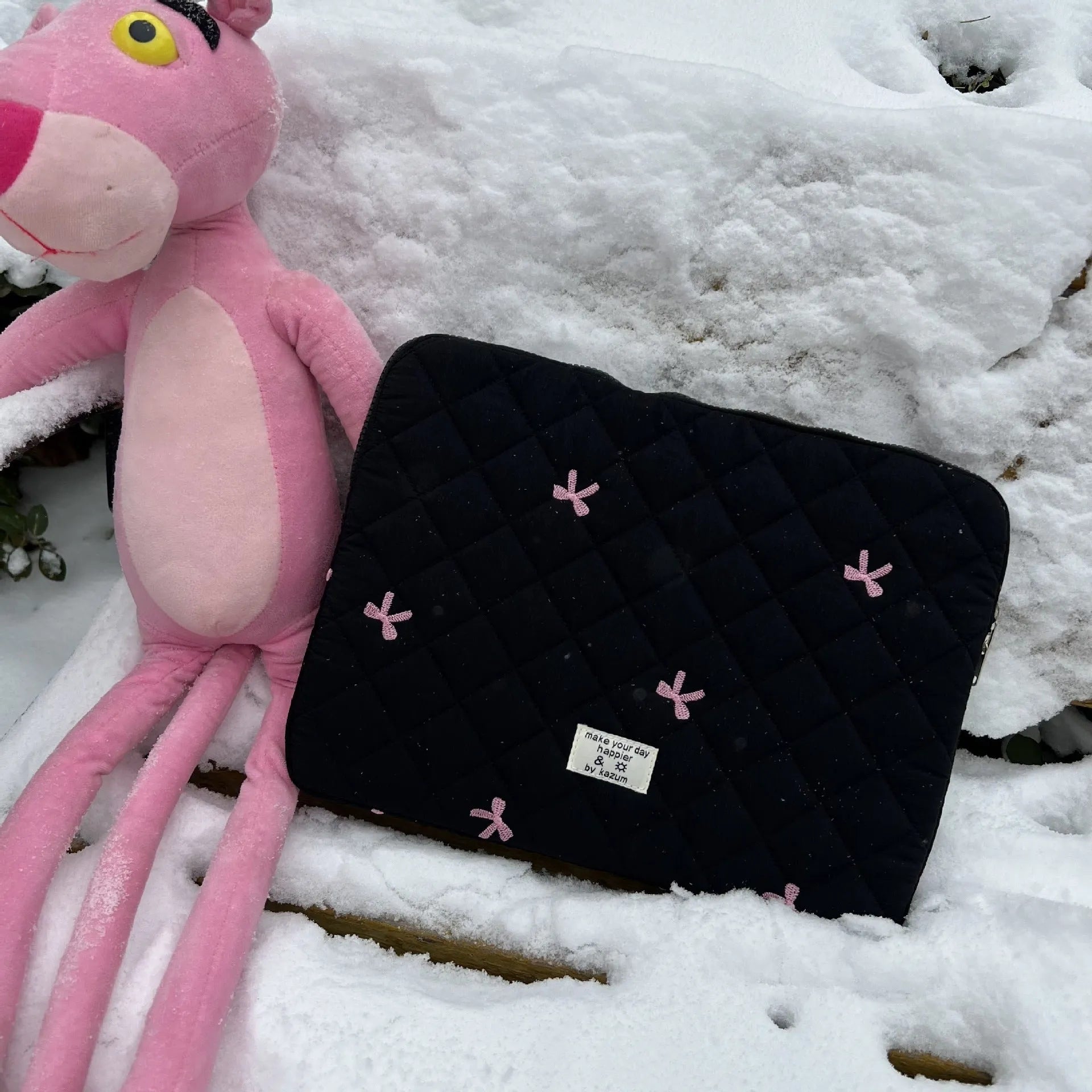 White nylon laptop bag with a light blue embroidered rhombus bow on the front
