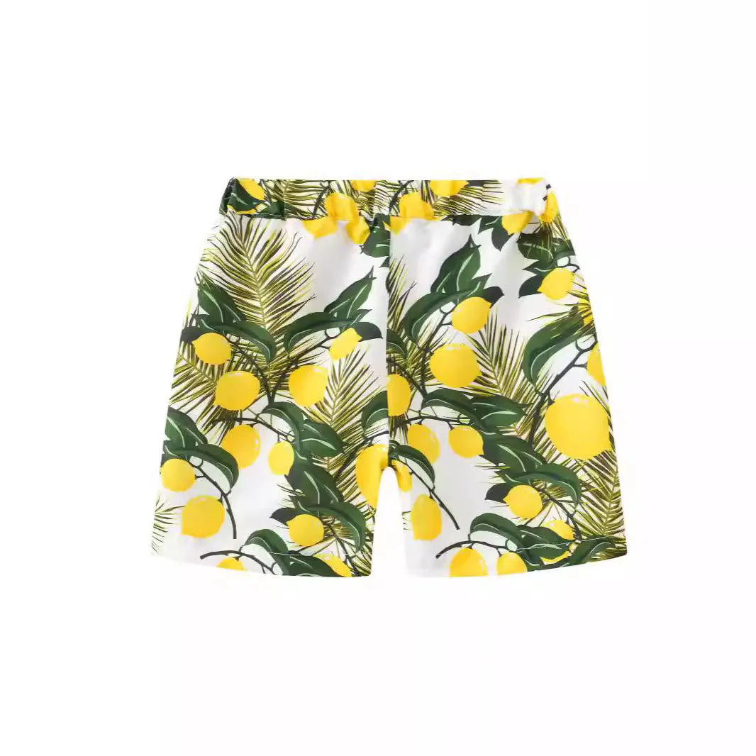 Multi-colour printed beach shorts with elastic waist for children on a summer background