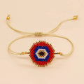 Hand-woven glass bead bracelet with blue eyes devil eyes motif on white background