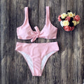 Women's solid colour bikini set in polyester with high-cut briefs, shown in wine red.