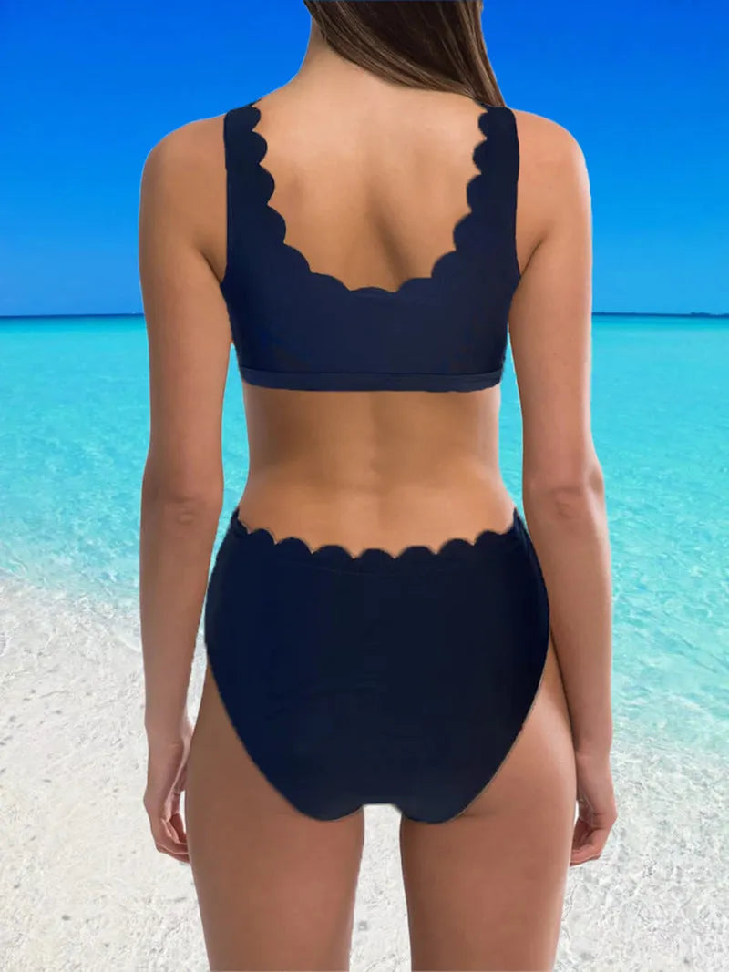 Red high-waisted women's two-piece swimsuit with a gathering split detail on a mannequin.