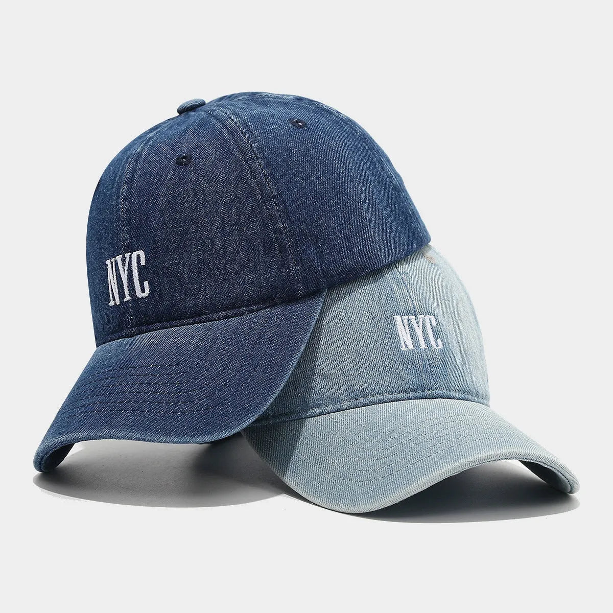Adjustable denim peaked cap with embroidered lettering in light blue, dark blue, or black