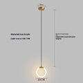 Minimalist black U-shaped pendant light with a downward-facing bulb mounted next to a bed.