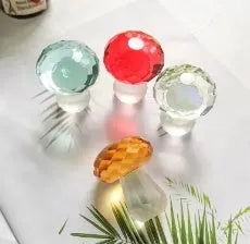 Small decorative crystal mushroom ornament in modern geometric style on a plain background.