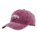 Retro distressed beige cap with adjustable strap and embroidered letters on a conical crown.