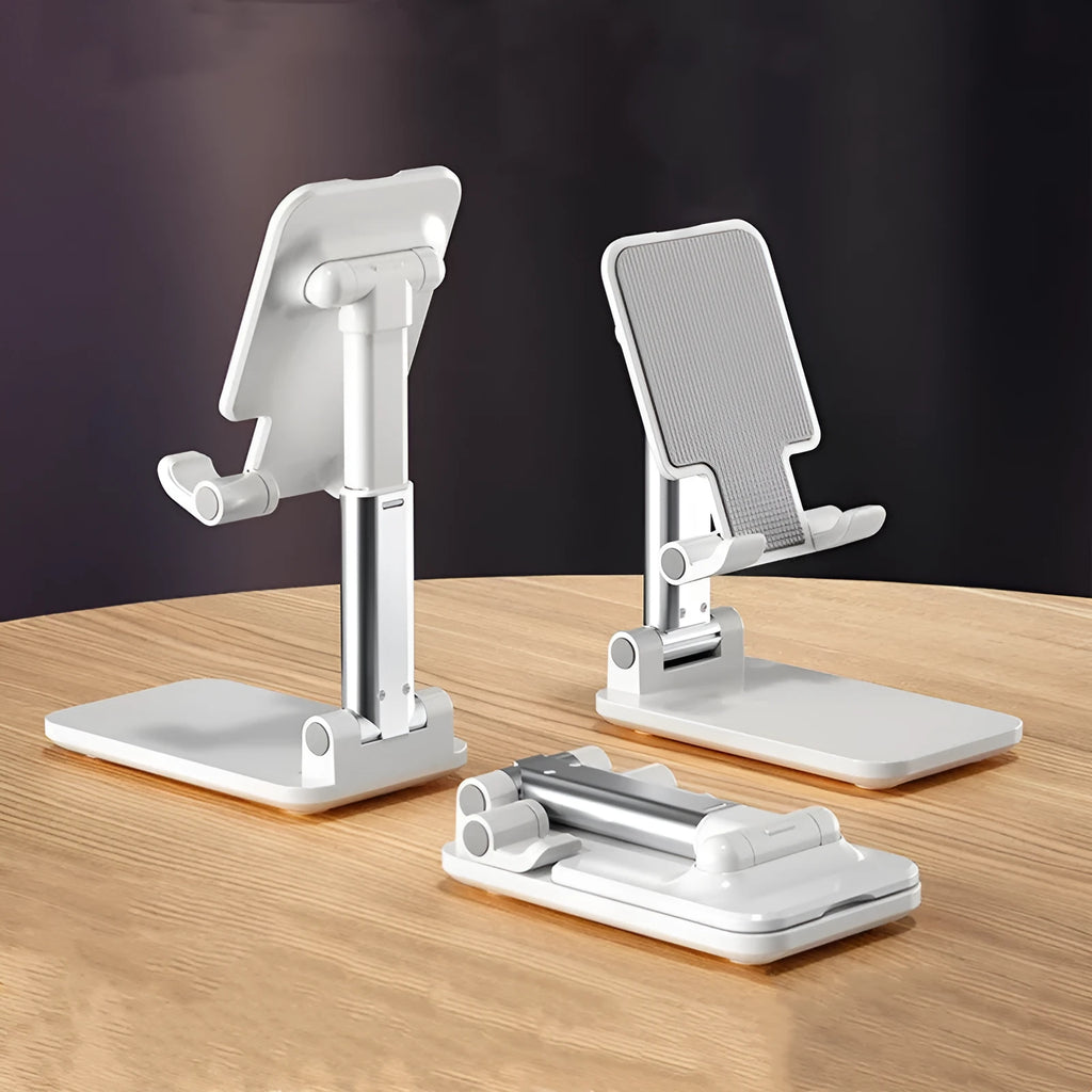White folding telescopic mobile phone holder with silicone pad on a desktop, holding a smartphone at an angle.