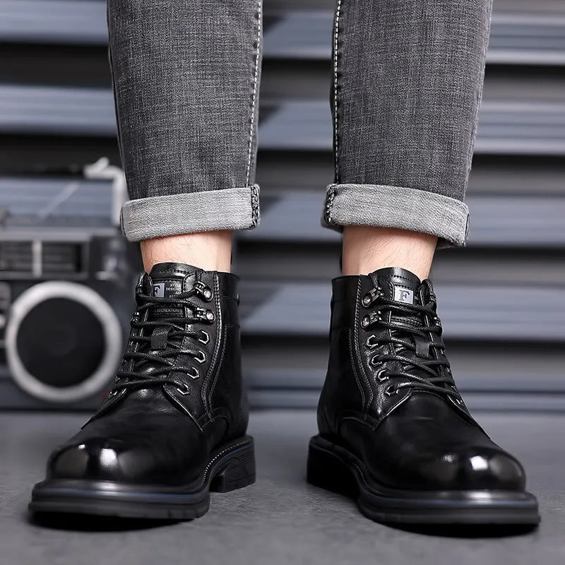 Black and brown leather Martin ankle boots with a rubber sole and visible stitching.