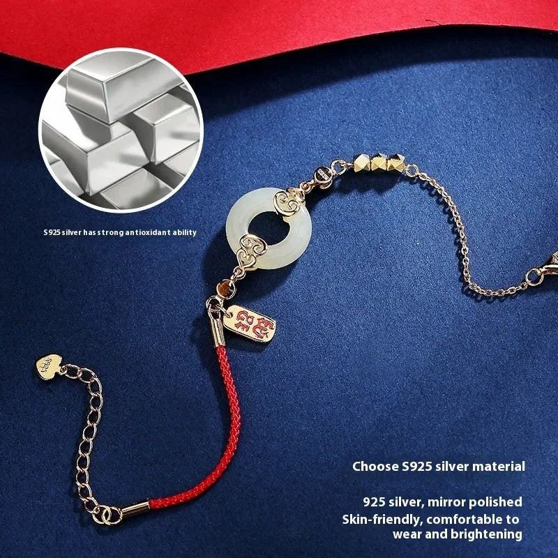 Women's Chinese style Hetian jade and sterling silver jewellery set showing bracelet, necklace, and earrings.